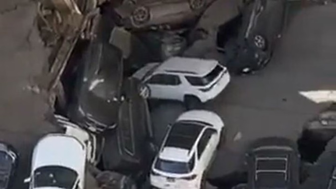 A parking garage in Lower Manhattan has partially collapsed leaving cars destroyed and people trapped. Photo / Pix 11