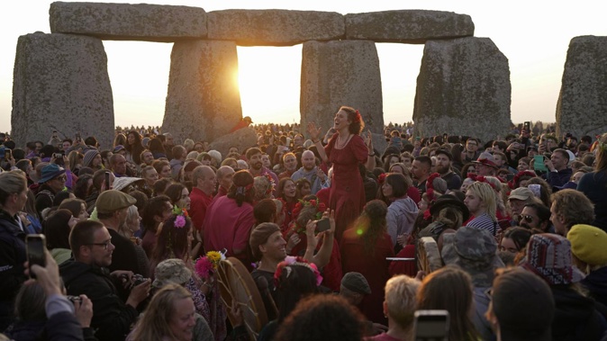 Revellers gather at the ancient stone circle Stonehenge to celebrate the Summer Solstice, the longest day of the year, near Salisbury, England. Photo / Kin Cheung, AP