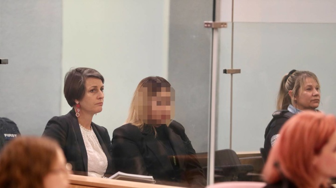 A woman with name suppression (centre) is on trial in the High Court at Auckland, accused of having helped kidnap and murder 17-year-old Dimetrius Pairama in July 2018. Photo / Michael Craig