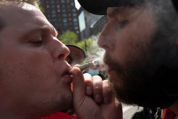 Michael Keren, left, and Scott Kisch smoke a marijuana cigarette during a 'Joints for Jabs' event in 2021. Photo / AP