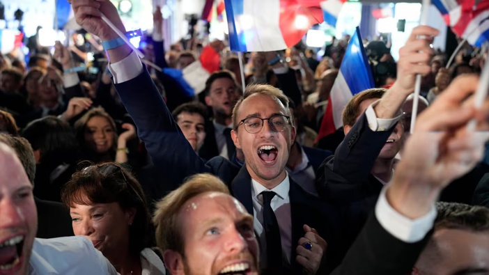 Supporters of French far-right party National Rally react at the party's election night headquarters on Sunday, June 9, 2024 in Paris. First projected results from France put the far-right National Rally party well ahead in EU elections, according to French opinion poll institutes. AP Photo / Lewis Joly