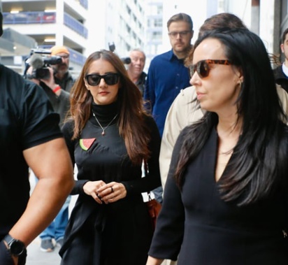 Former Green MP Golriz Ghahraman has arrived at Auckland District Court for sentencing on shoplifting charges, flanked by supporters including her ex Guy Williams. Photo / Dean Purcell