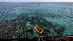 FILE - A Philippine Marine, right, swims in the waters of Second Thomas Shoal in the South China Sea, on March 30, 2014. A Chinese vessel and a Philippine supply ship collided near the disputed Spratly Islands in the South China Sea on Monday, June 17, 2024, China’s coast guard said. (AP Photo/Bullit Marquez, File)