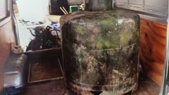 A large metal cylinder, alleged to be used in the manufacture of methamphetamine, had to be removed from a suspected clan lab by helicopter.