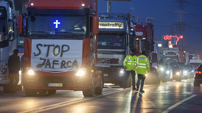 Protesting truck drivers slow traffic down on a road leading to Bucharest, in Afumati, Romania. Photo / AP