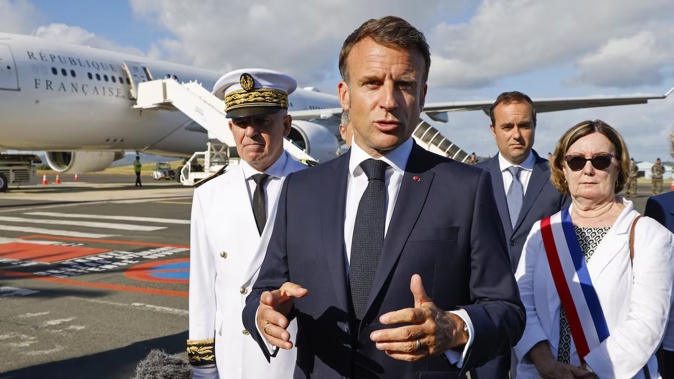 French President Emmanuel Macron speaks with the press upon arrival at Noumea. Photo / AP