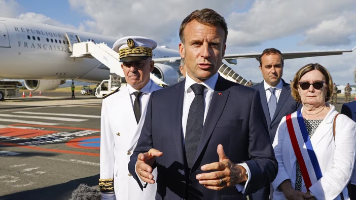 French President Emmanuel Macron speaks with the press upon arrival at Noumea. Photo / AP