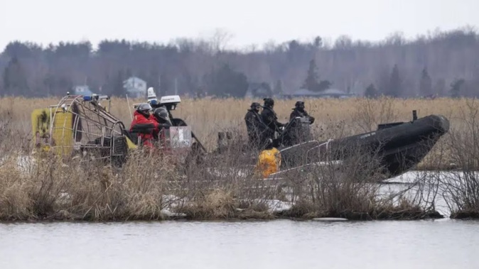 Searchers look for victims in Akwesasne, Quebec. Photo / AP
