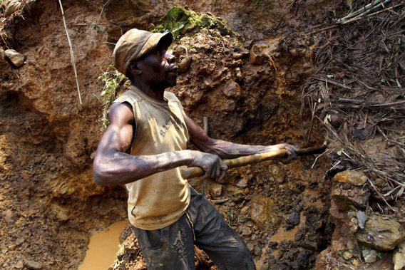 FILE- In this Aug. 17, 2012 file photo, a Congolese miner digs for cassiterite, the major ore of tin, at Nyabibwe mine, in eastern Democratic Republic of Congo. Increased violence and corruption in central Africa could be the result of the recent decision by the U.S. Securities and Exchange Commission not to enforce a rule requiring American companies to report their use of conflict minerals, warn Congolese civic groups, rights groups and U.S. senators. (AP Photo/Marc Hofer, file)