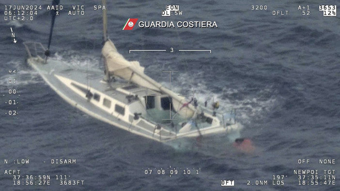 This picture taken early Monday, June 17, 2024 by the Italian Coast Guard shows a sail boat used by migrants half sank in the Mediterranean Sea between Italy and Greece early Monday, June 17, 2024. (Italian Coast Guard via AP, Ho)