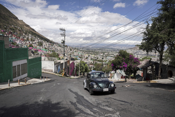 Janette Navarro drives her 1996 Volkswagen Beetle up a steep hill in the Cuautepec neighborhood of Mexico City, Friday, June 21, 2024. Taxi drivers like Navarro say they continue to use the Beetles because the cars are historically inexpensive and the engine located in the back of the vehicle gives it more power to climb the neighborhood's steep hills. (AP Photo/Aurea Del Rosario)
