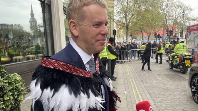 Prime Minister Chris Hipkins wearing a suit and kakāhu as he departs for the Coronation. Photo: RNZ / Katie Scotcher