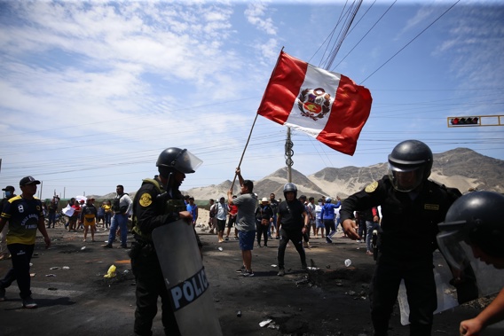 Supporters of ousted Peruvian President Pedro Castillo protest on the Pan-American North Highway while police officers arrive to clear debris, in Chao, Peru, Thursday, Dec. 15, 2022. Photo / AP
