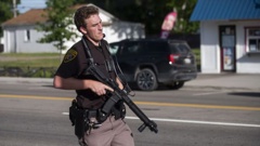 An officer secures the scene of a shooting at the Brooklands Plaza Splash Pad. Photo / AP