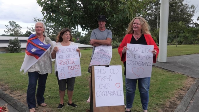 Those opposed to Julian Batchelor's views make their feelings clear outside the meeting in Kerikeri. Photo / RNZ, Sam Olley